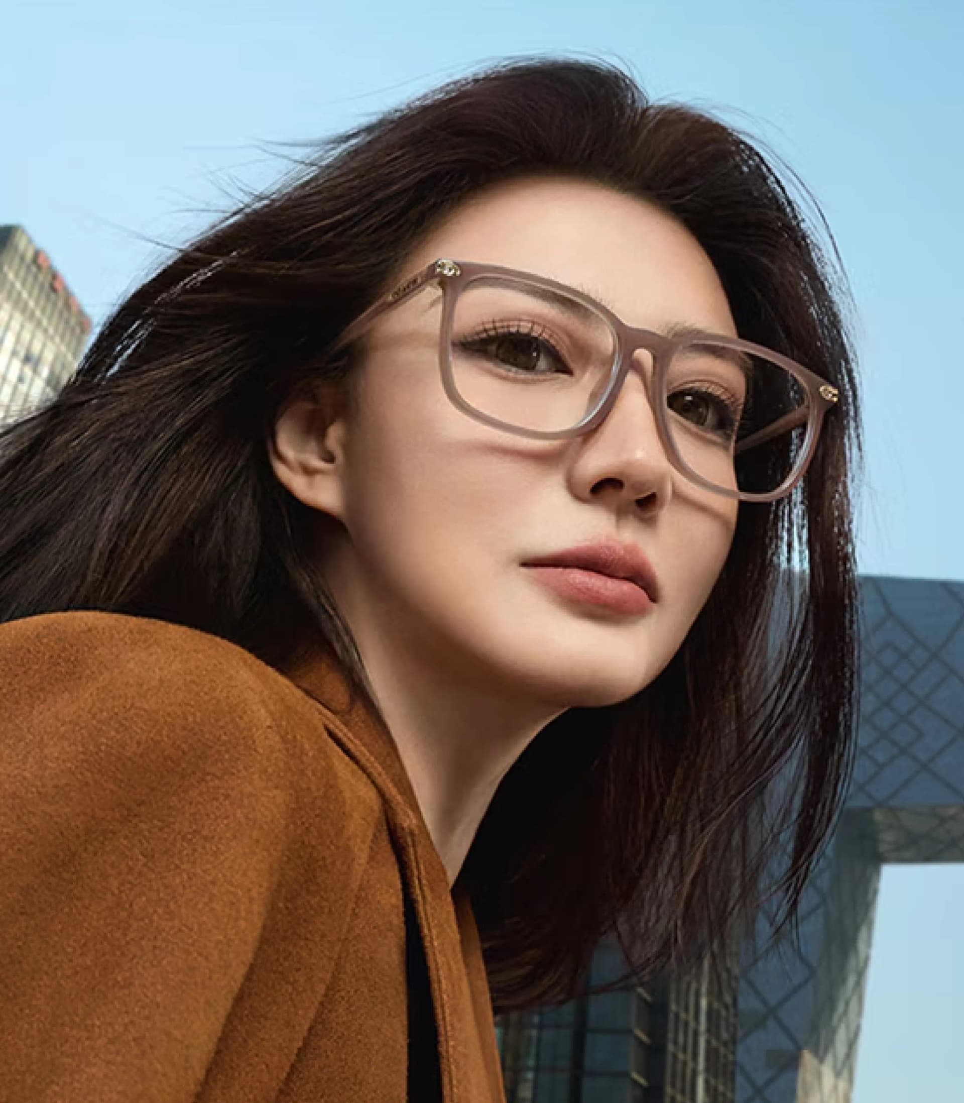 Woman with round eyeglasses looking at camera