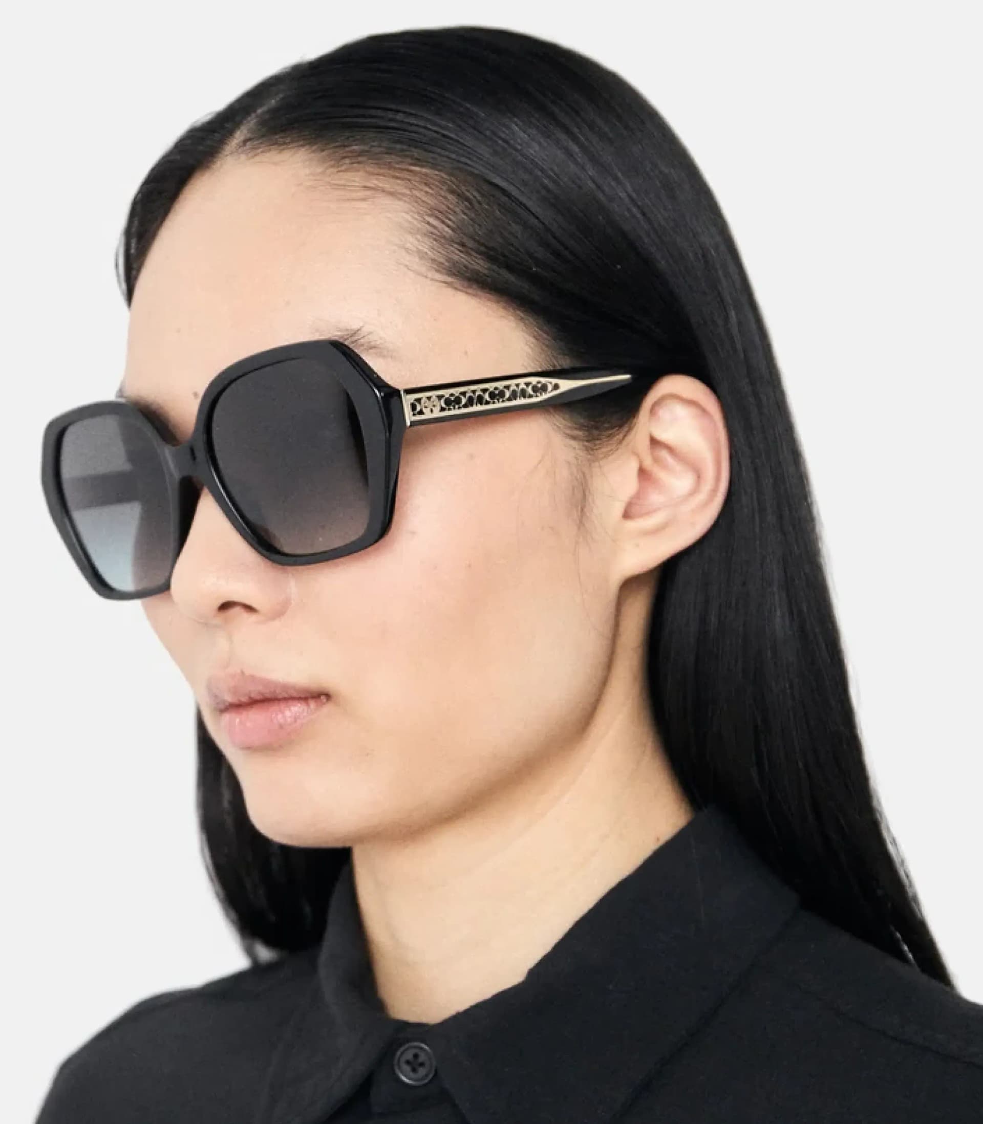 Woman with large round sunglasses looking up