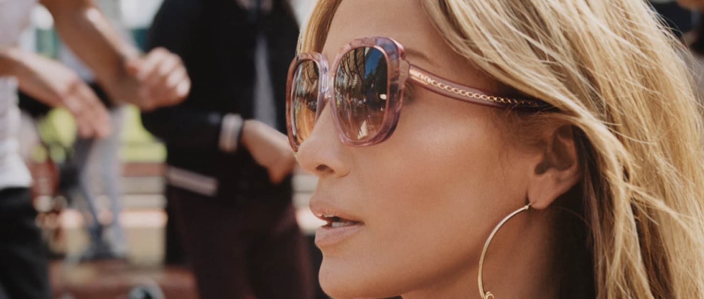 Woman wearing Coach sunglasses